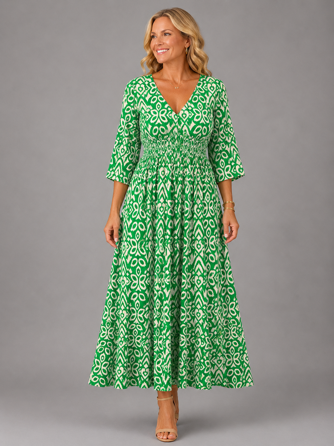 Althea smocked ikat-print midi dress in green, full-length front view