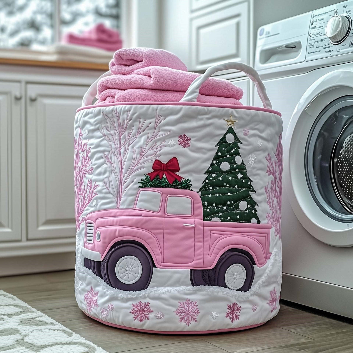 Giada hand-quilted laundry basket with a pink vintage truck carrying a Christmas tree among pink snowflakes, front view