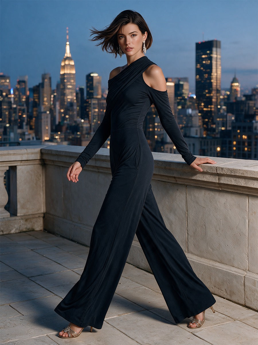Temperance draped jumpsuit in black, walking on an evening terrace