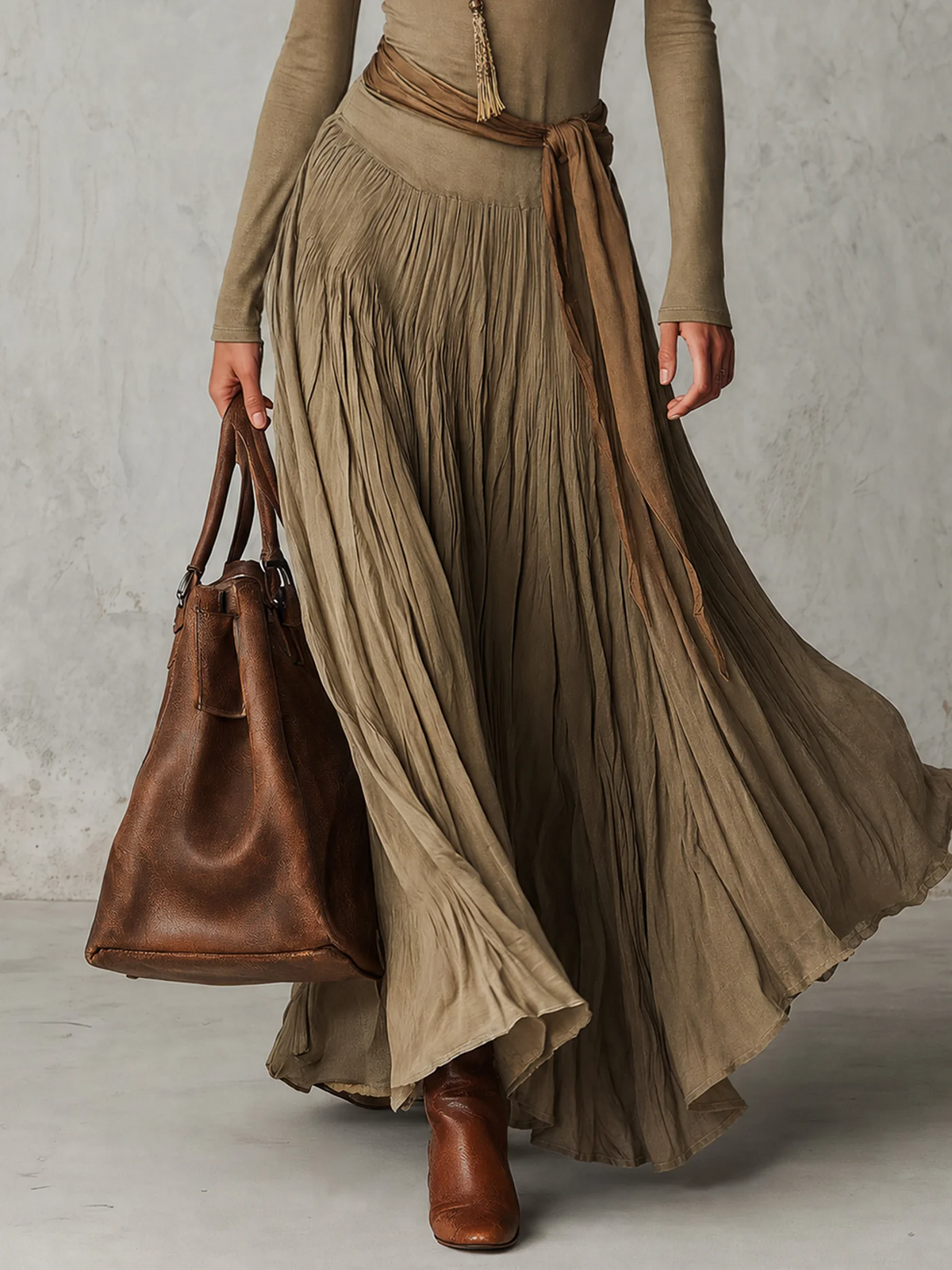 Gina pleated maxi dress in olive green, close-up of flowing pleated skirt