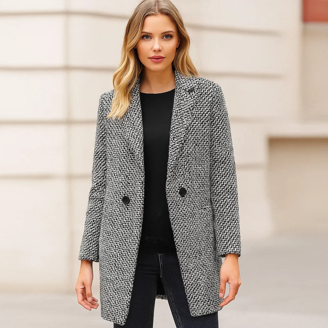 Venetia long wool coat in black and white, worn open over a black top