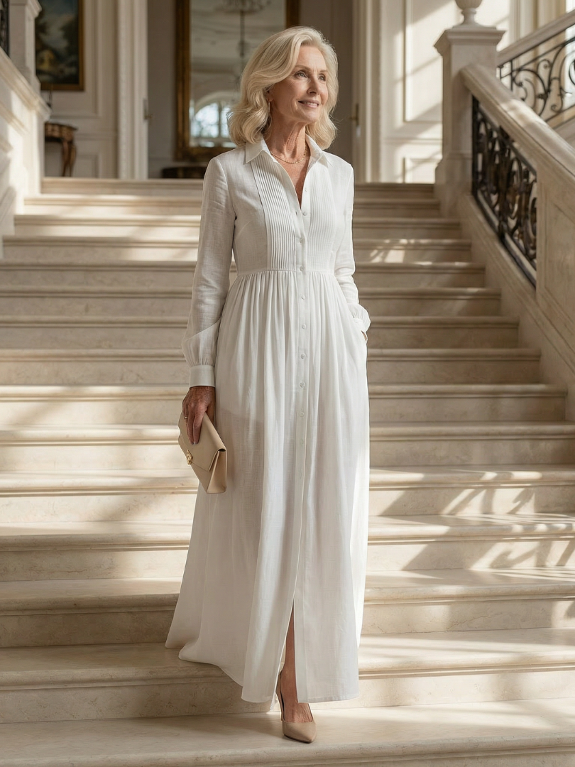 Greer pintucked maxi shirt dress in white, worn on a sunlit staircase