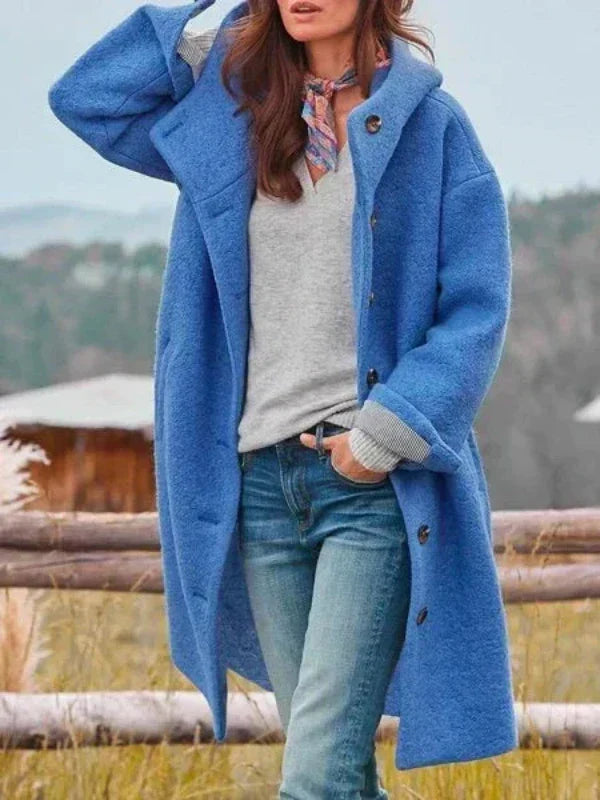 Virginia long hooded coat in blue, worn open over jeans