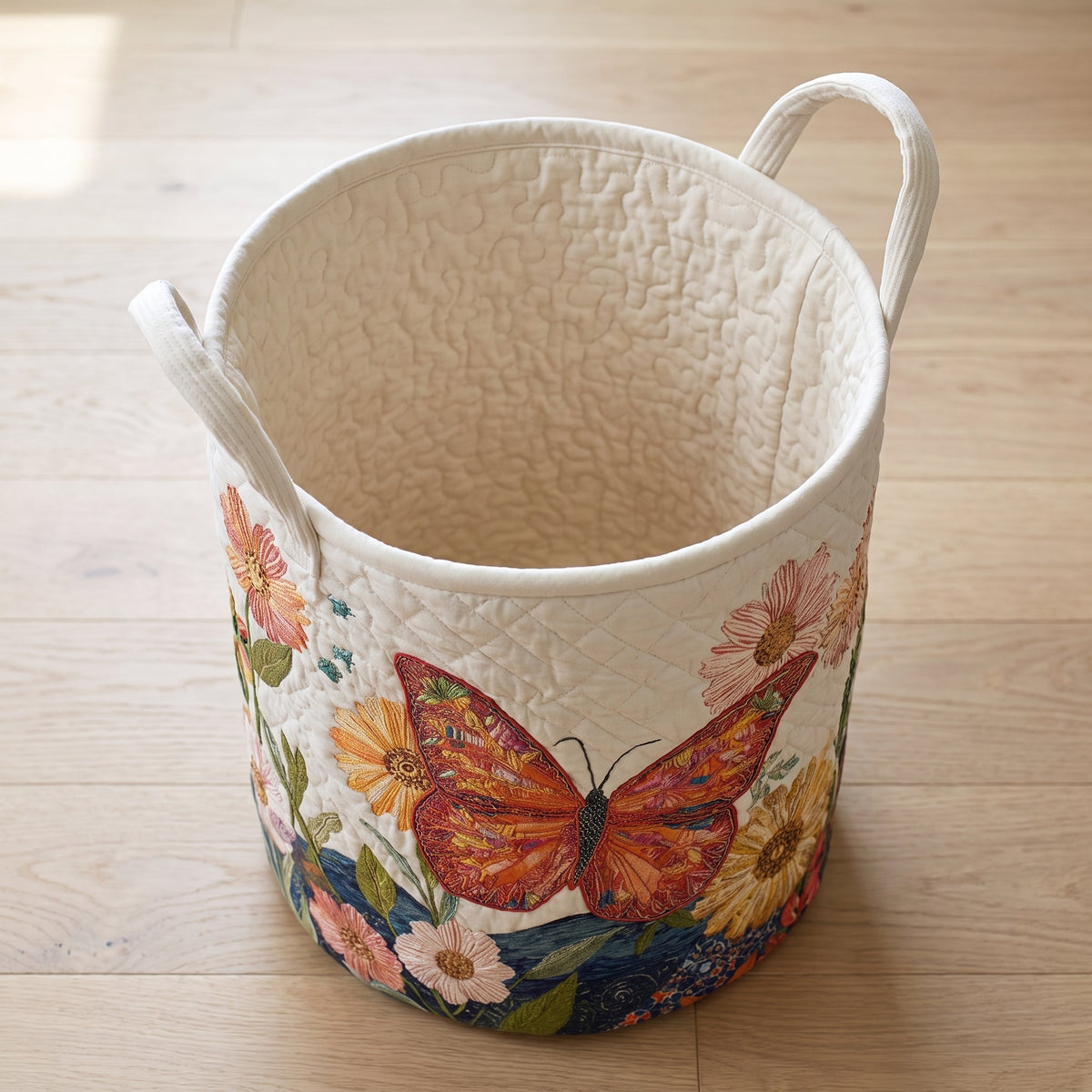 Linda hand-quilted laundry basket with an orange butterfly among colourful garden flowers, open empty view