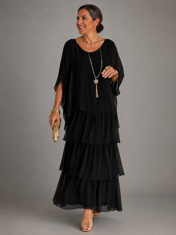 Lara tiered maxi dress in black, full-length front view with sheer cape overlay