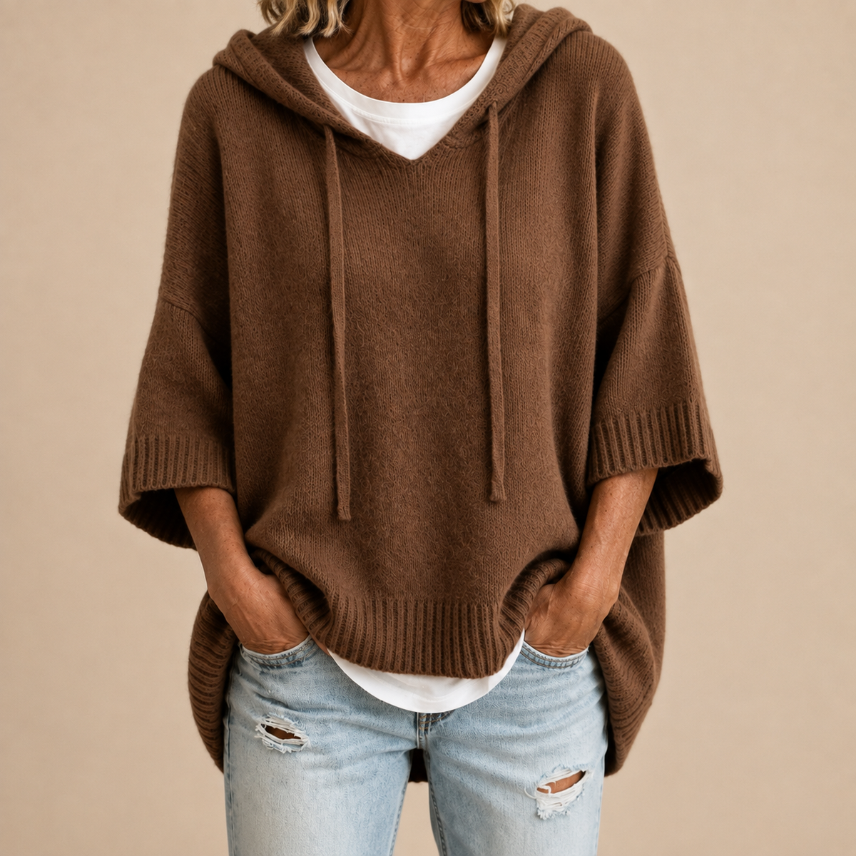 Hooded knit poncho in brown, front view
