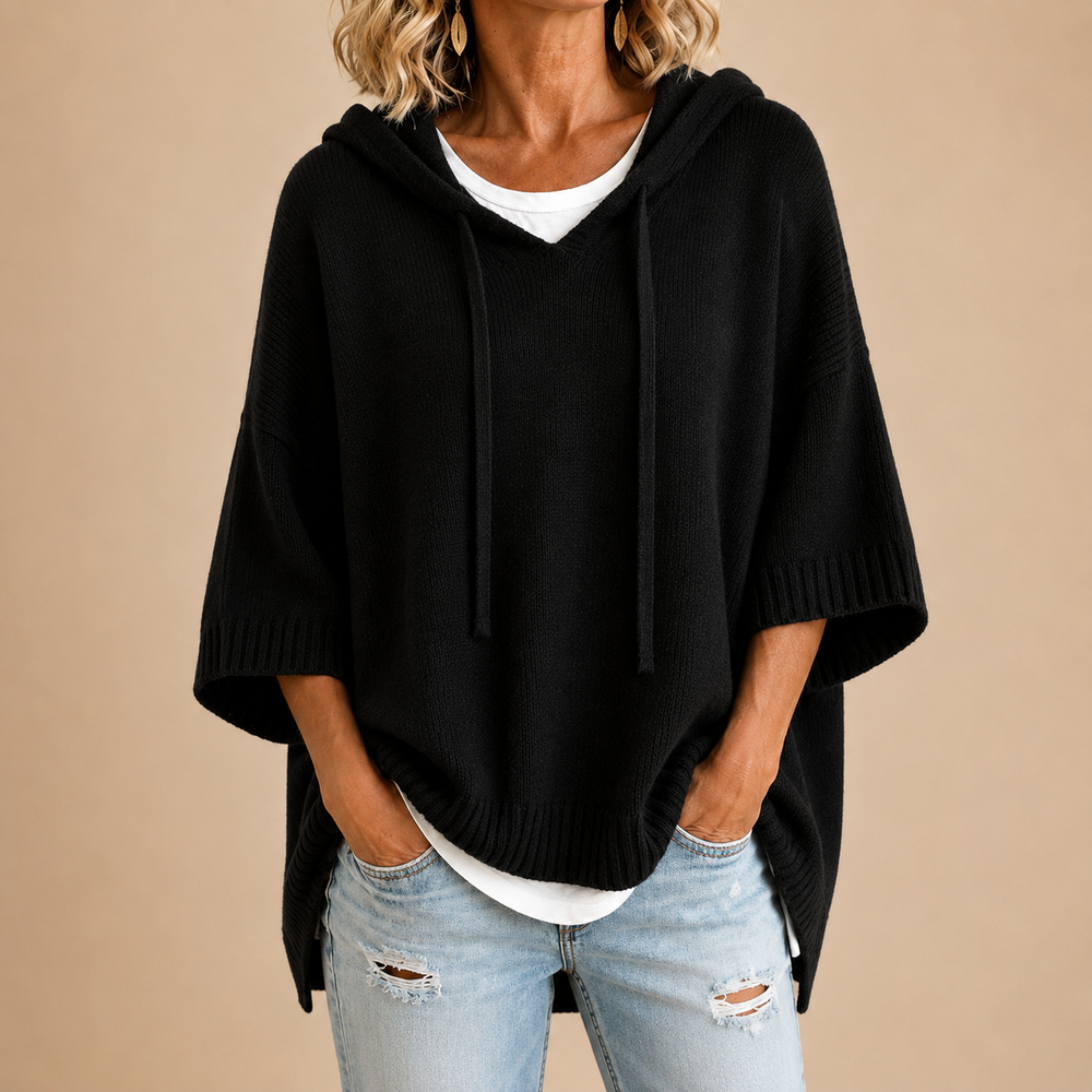 Hooded knit poncho in black, front view