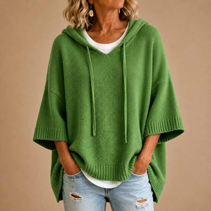 Hooded knit poncho in green, front view