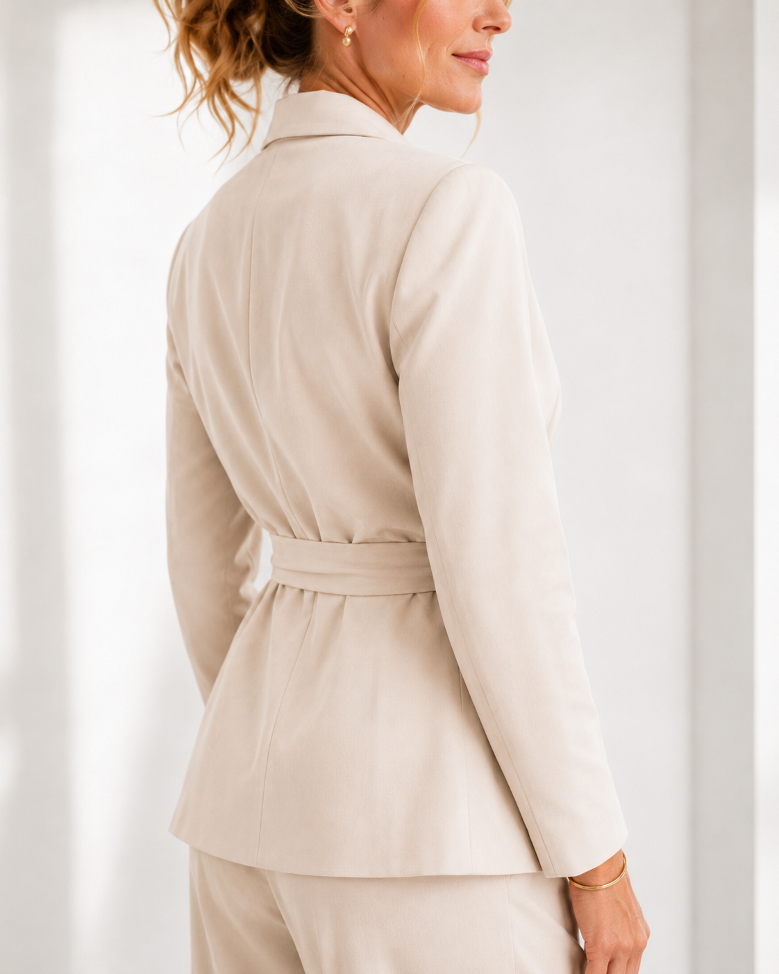 Winifred belted wrap trouser suit in beige, back view of the belted blazer