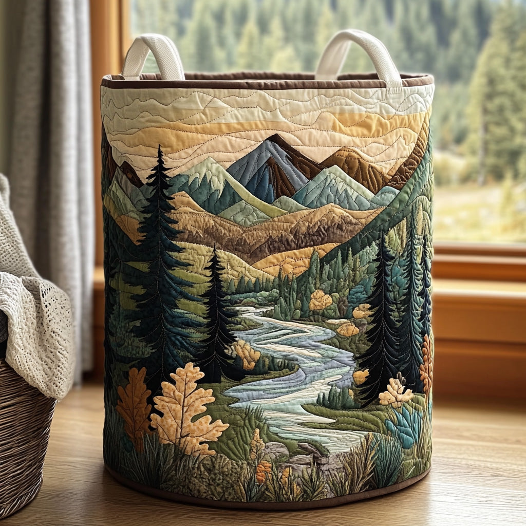 Dora hand-quilted laundry basket with a mountain valley, pine trees and a winding stream, front view