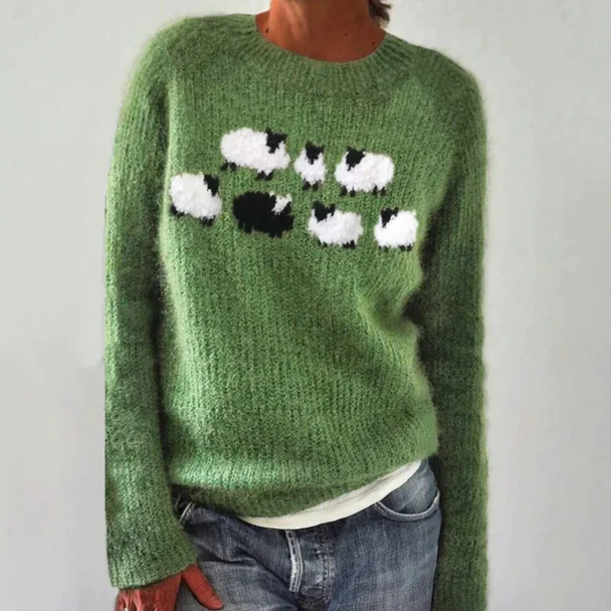 Stella retro Scandinavian knitted sweater in green with white and black sheep motif, front view