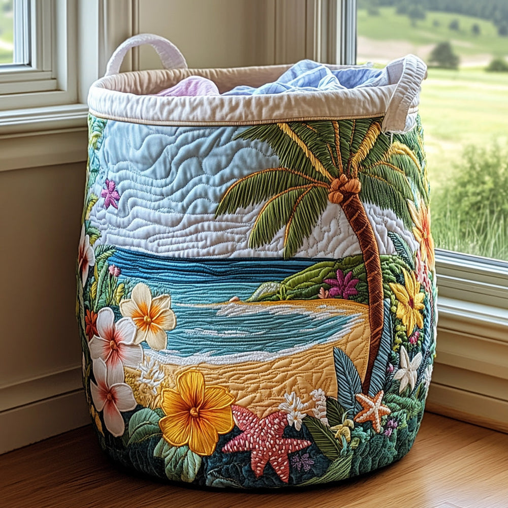 Rosella hand-quilted laundry basket with a palm-fringed beach and tropical flowers, front view by a window