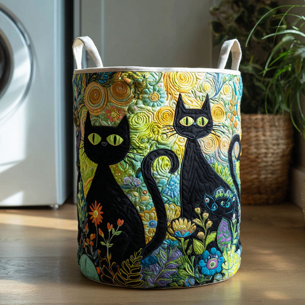 Rebecca hand-quilted laundry basket with two black cats on a swirling yellow background, front view in a laundry room