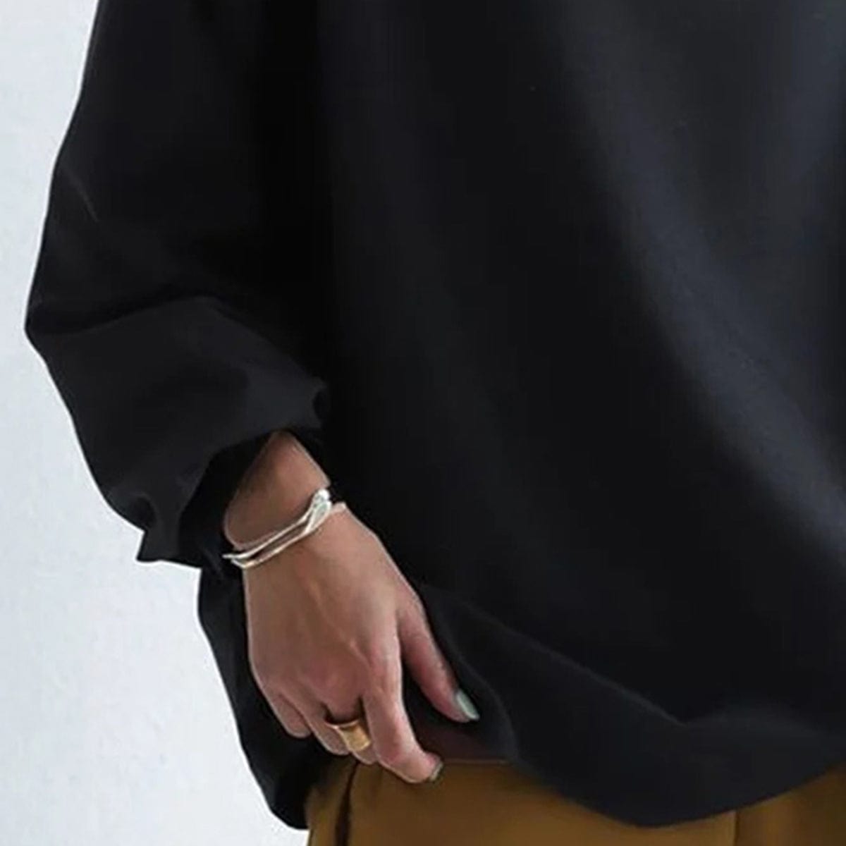 Elly funnel-neck relaxed top in black, sleeve detail