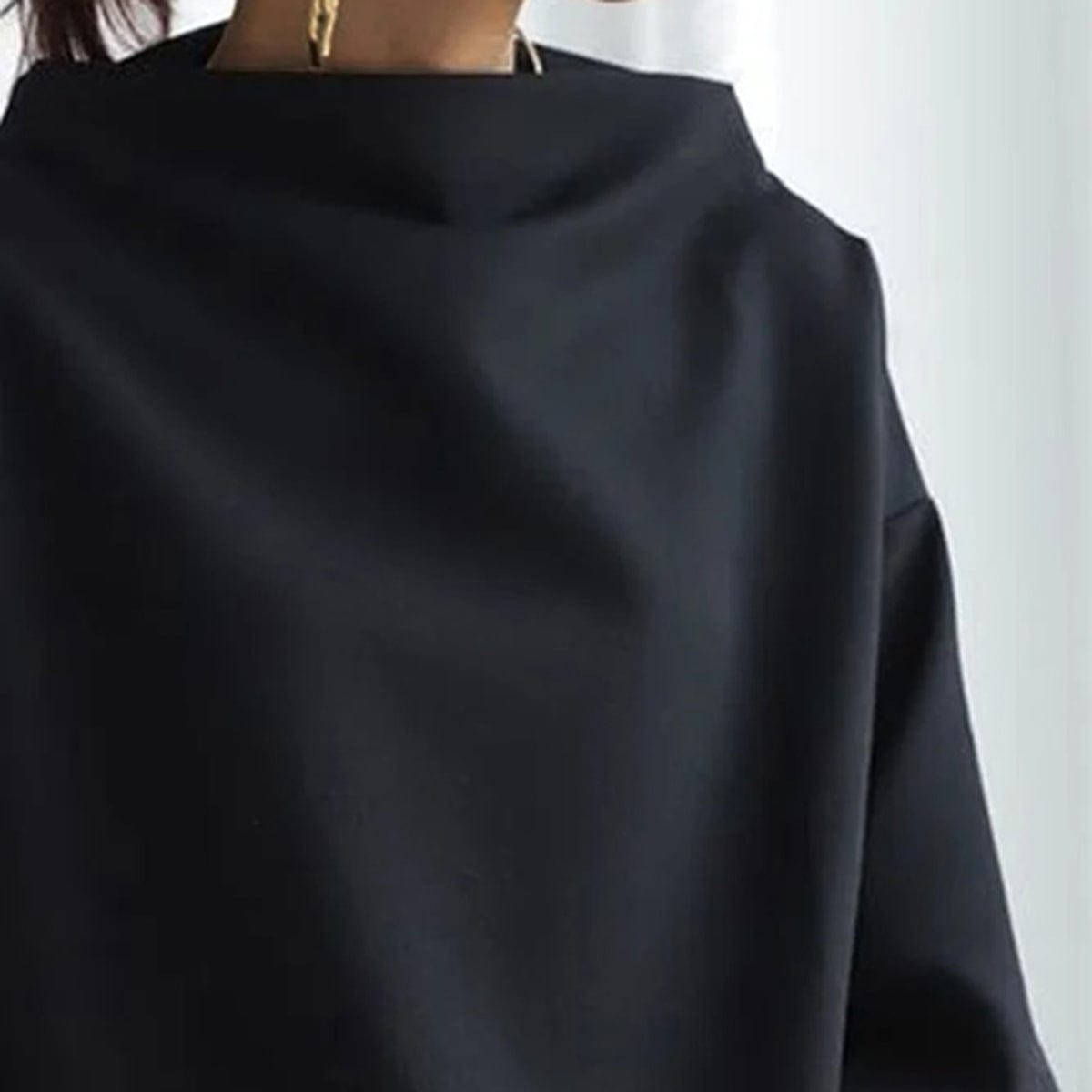 Elly funnel-neck relaxed top in black, neckline detail