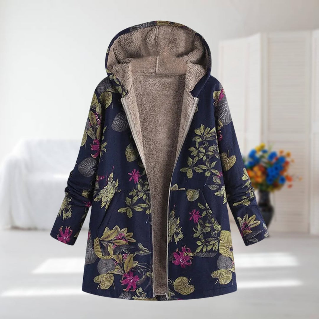 Nora floral hooded coat in navy with green leaves and pink flowers, front view on a hanger
