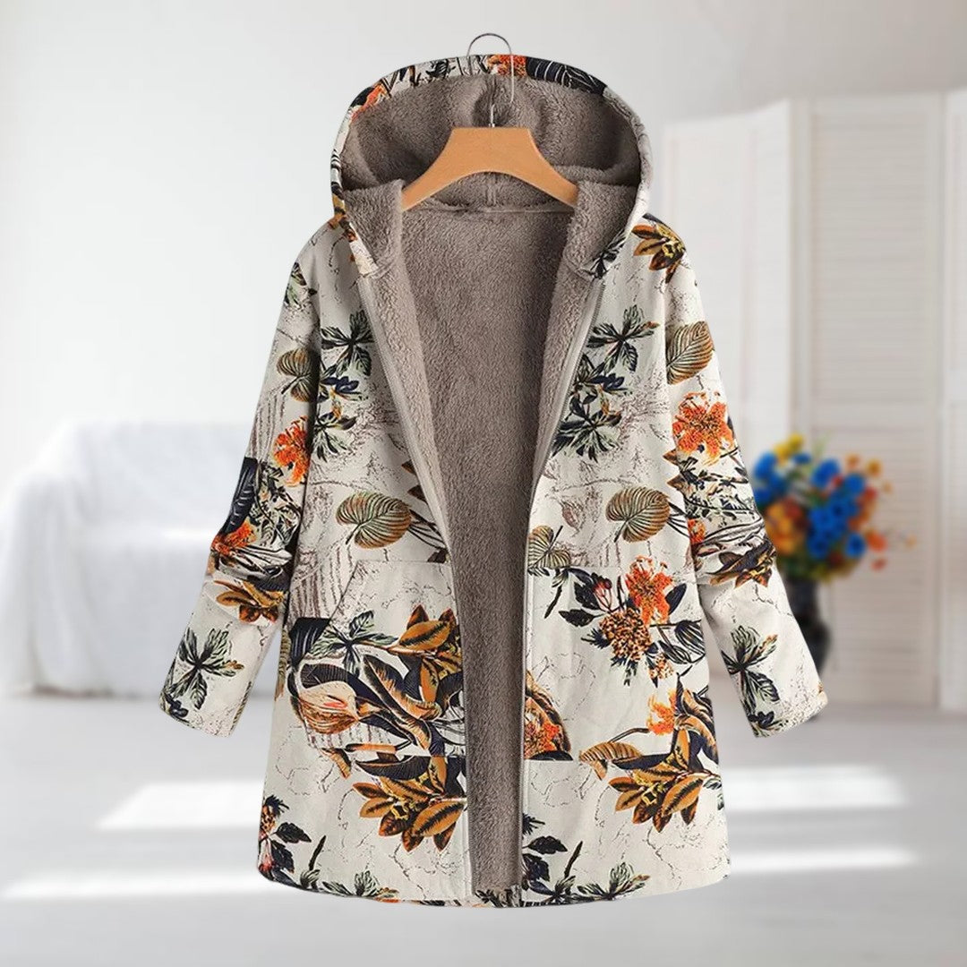 Clara hooded leaf print coat in cream and orange, front view on a hanger