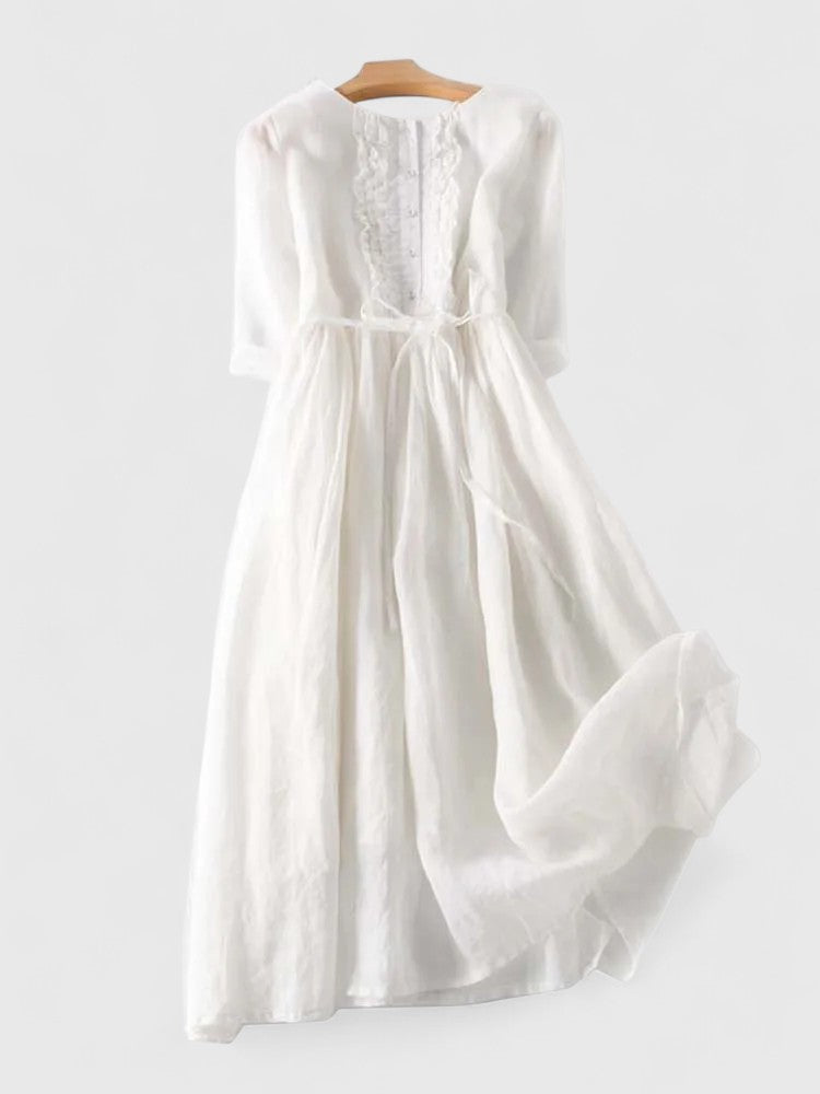 Kathryn ruffle-bib tie-waist dress in white on a hanger