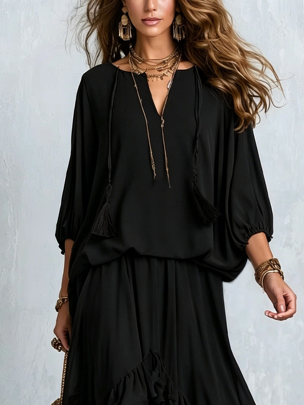 Tabitha black chiffon ruffle skirt set, close-up of V-neck with tassel ties and balloon sleeves