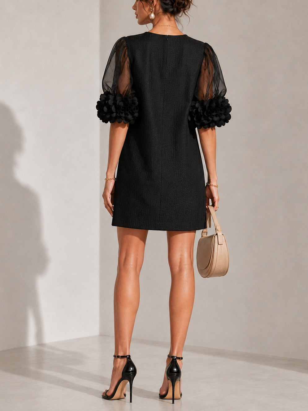 Minette puff-sleeve mini dress in black, back view