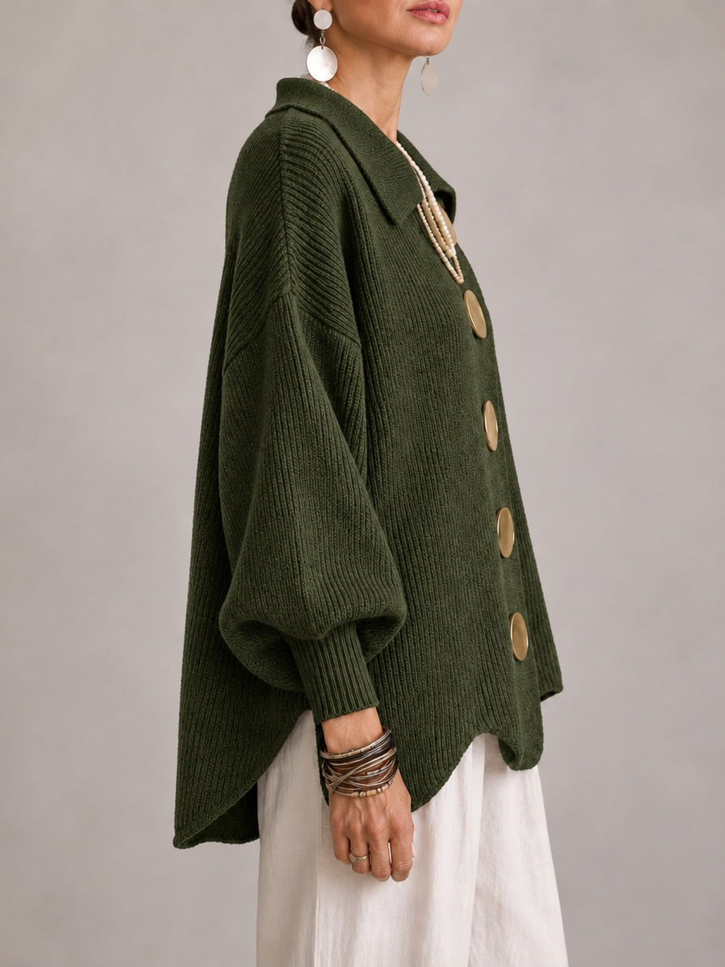 Elspeth oversized ribbed cardigan in olive green, side view with curved scalloped hem