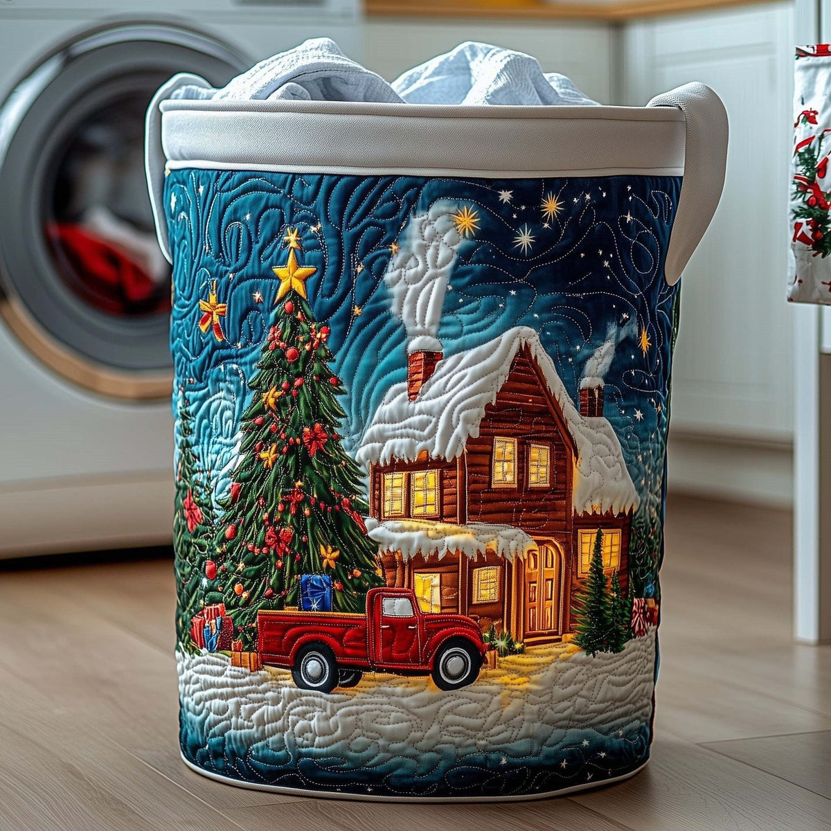 Gaia hand-quilted laundry basket with a glowing cottage, a Christmas tree and a red truck under a teal night sky, front view