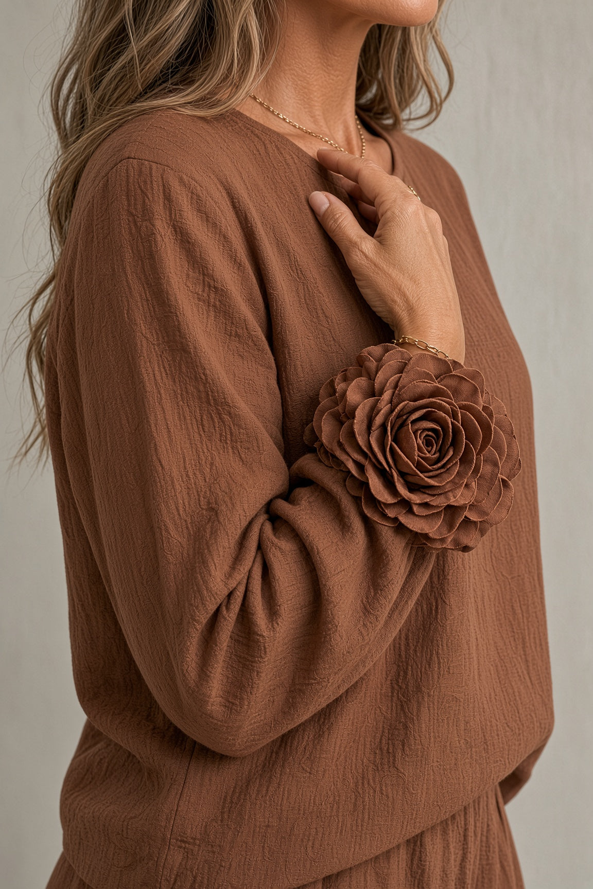 Bronwyn rosette cuff top and wide-leg trouser set in brown, close-up of rosette cuff