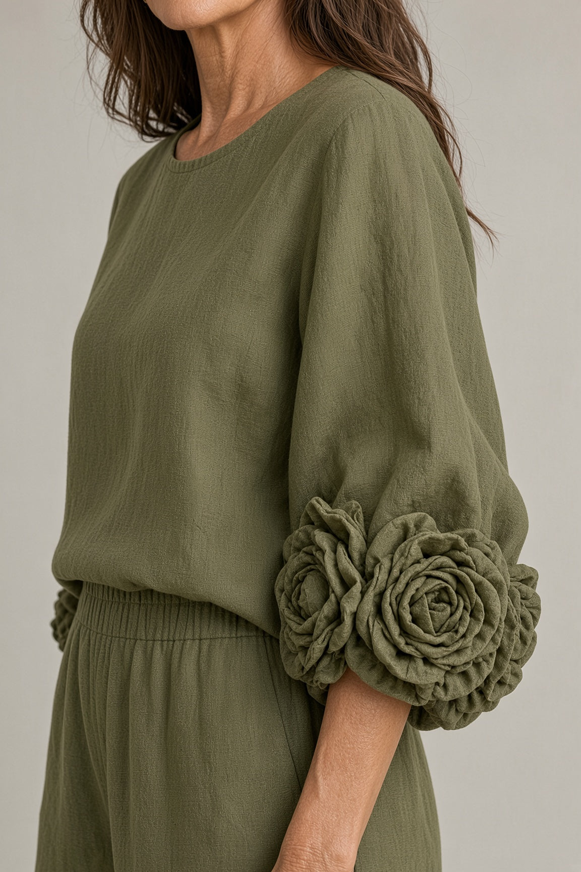 Bronwyn rosette cuff top and wide-leg trouser set in green, close-up of rosette cuff
