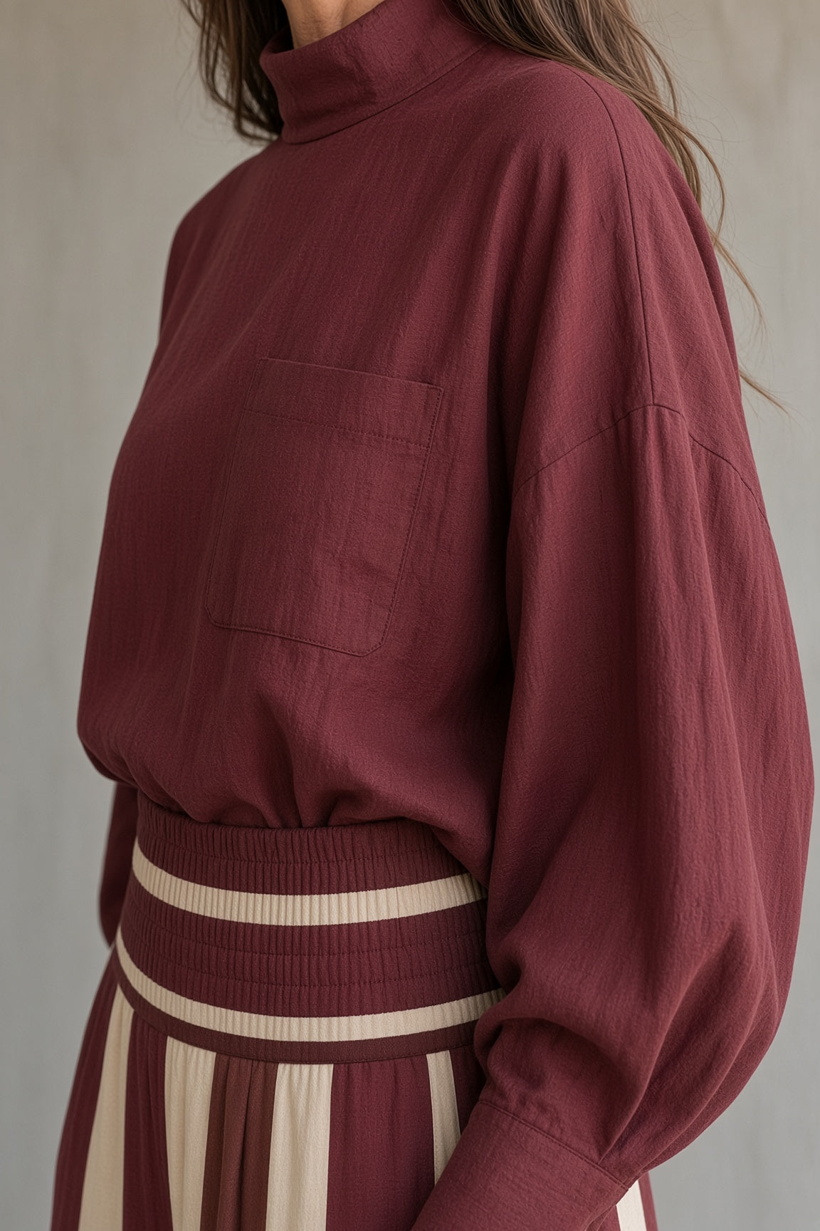 Rosaleen high-neck top and striped trouser set in red, close-up of pocket and smocked waistband