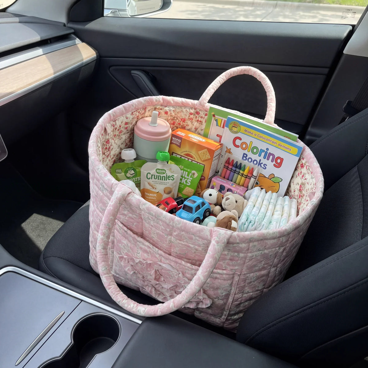Nancie quilted everything basket in Blush Rose, filled on a car seat