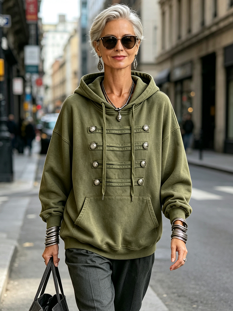 Shona military frogging hoodie in olive green, worn on a city street