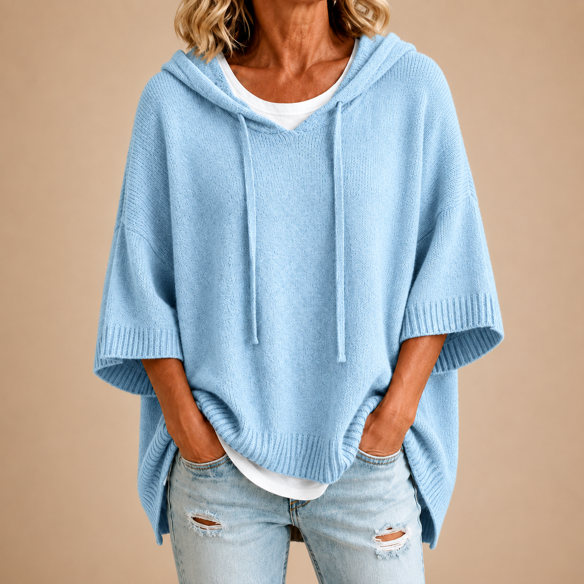 Hooded knit poncho in light blue, front view