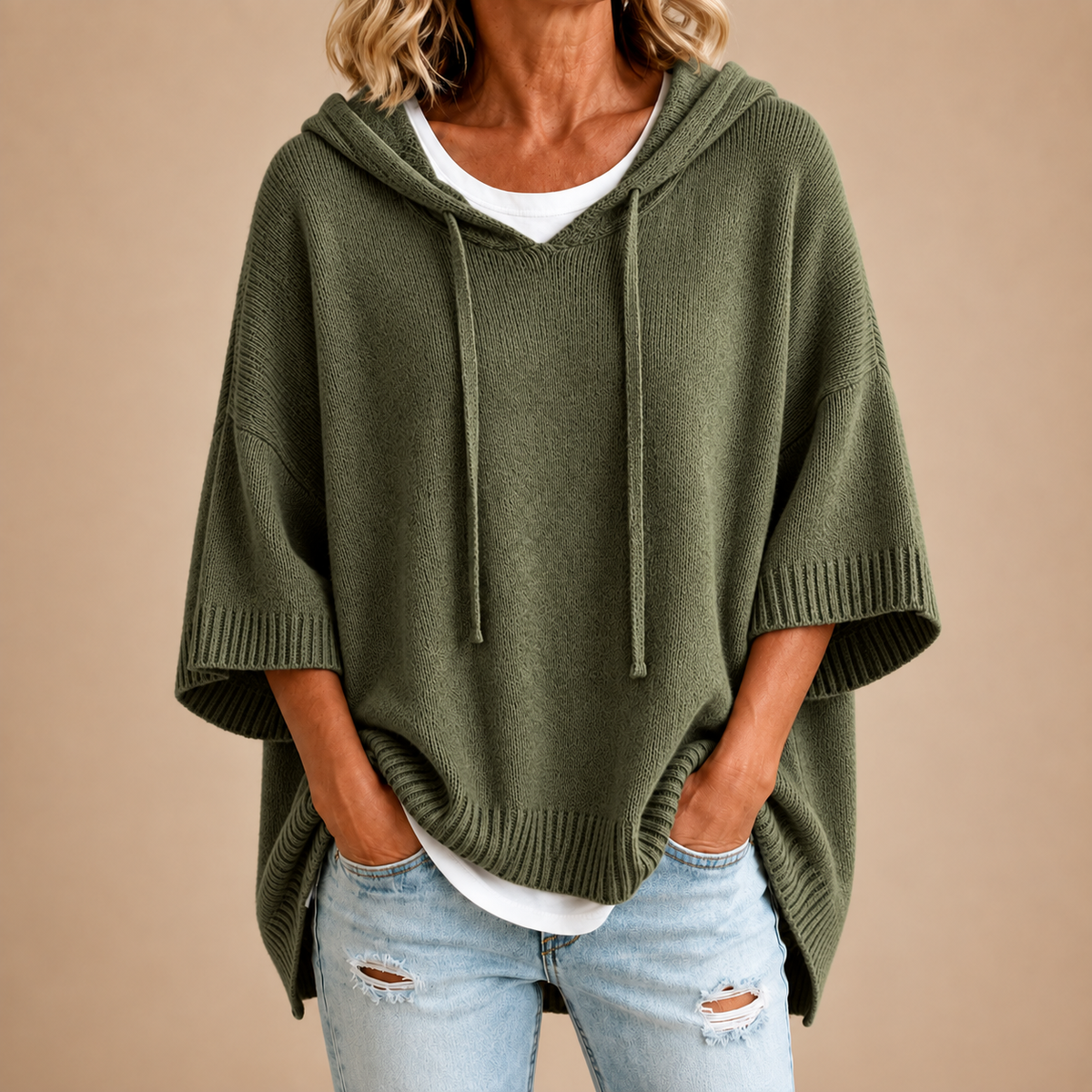 Hooded knit poncho in olive green, front view