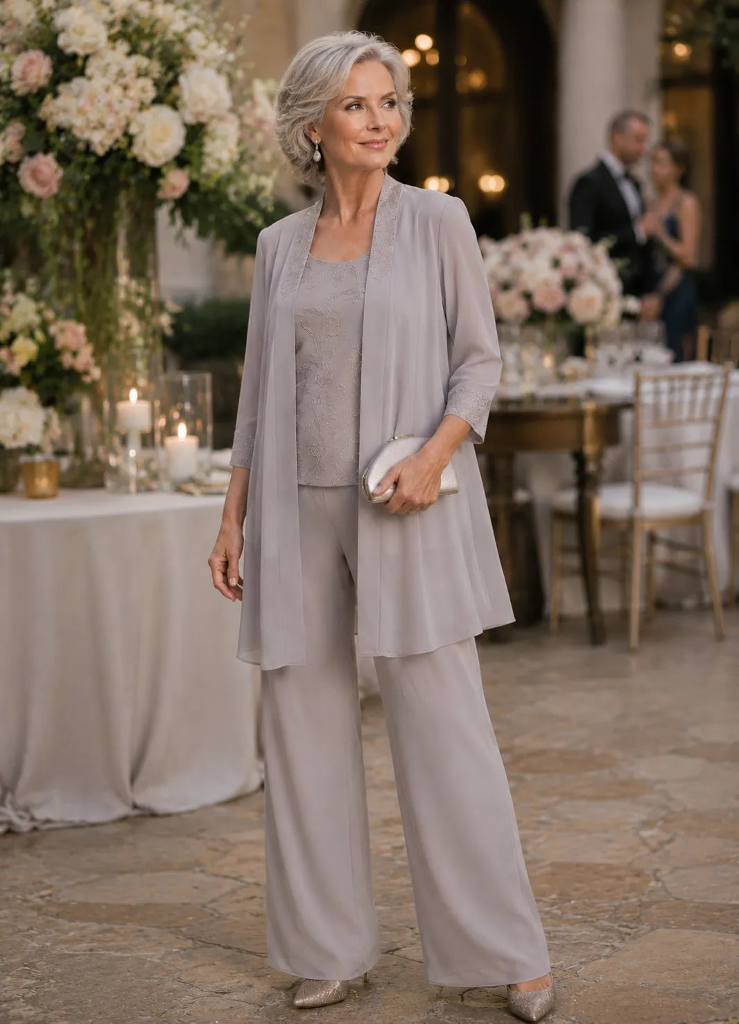 Anthea embroidered three-piece trouser suit in grey, full-length view at an evening reception