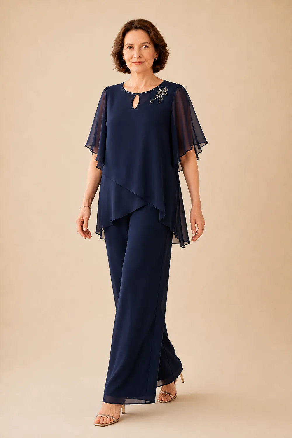 Annabel chiffon cape trouser suit in navy, walking view with flowing overlay
