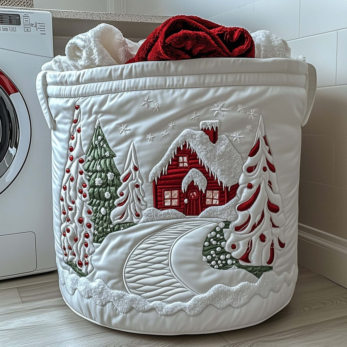 Gabriella hand-quilted laundry basket with a red cottage, a winding snowy path and Christmas trees, front view