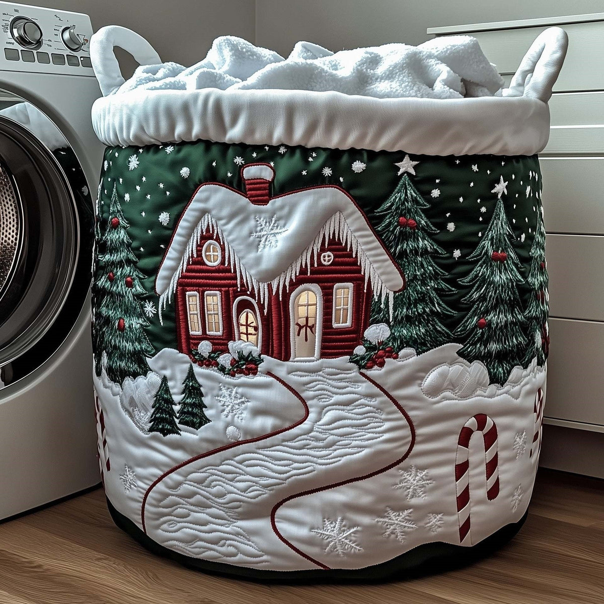 Licia hand-quilted laundry basket with a red cottage in a snowy evergreen forest, front view