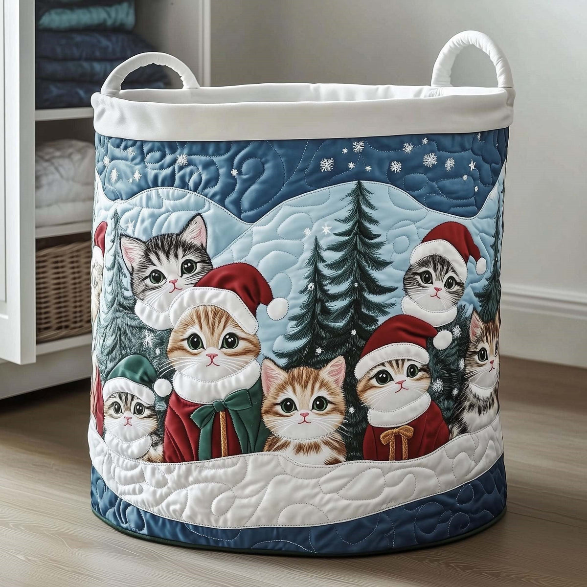 Giuseppina hand-quilted laundry basket with kittens in Santa hats among snowy pine trees, front view