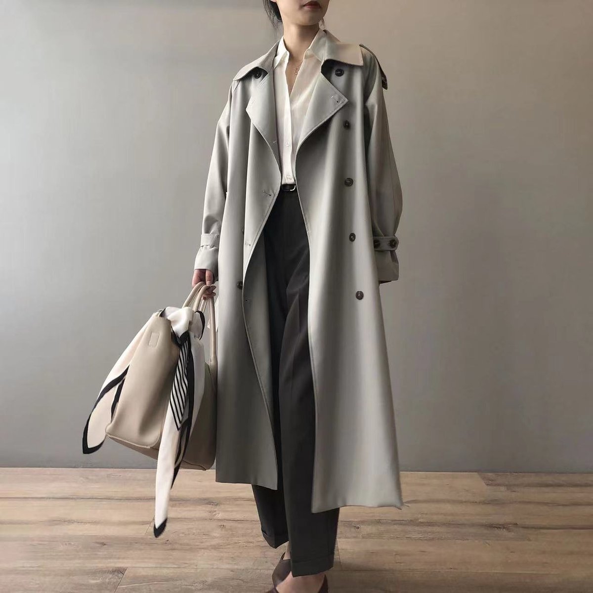 Katherine long double-breasted trench coat in grey, full-length front view with tote bag
