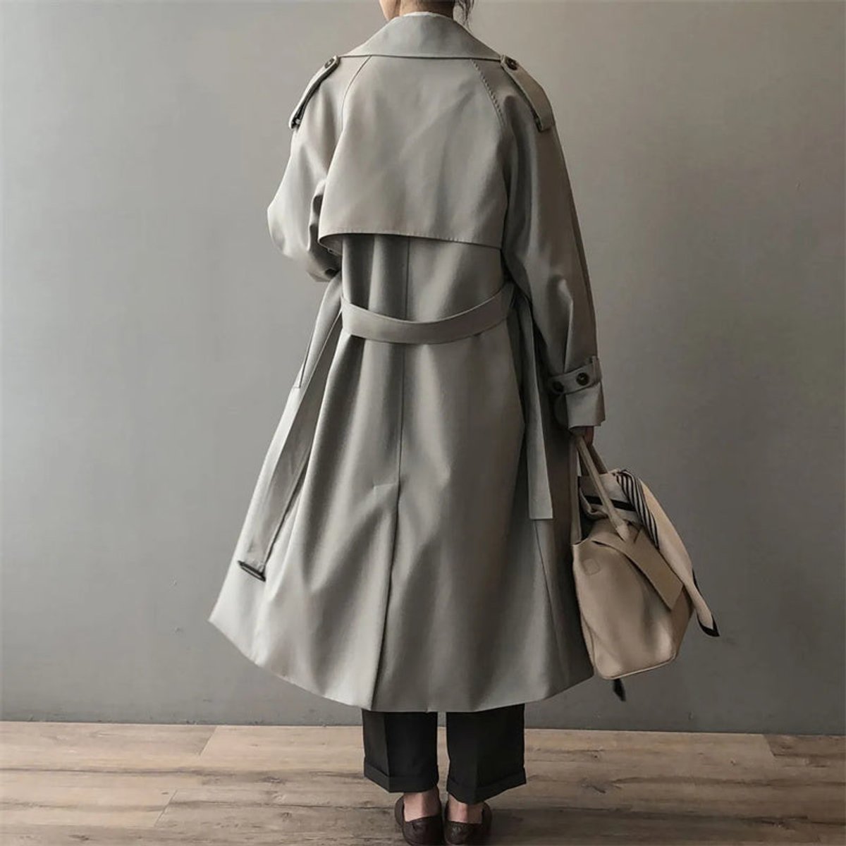 Katherine long double-breasted trench coat in grey, back view with storm yoke and belt