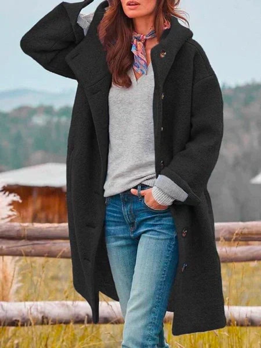 Eleanor long hooded coat in black, worn open over a grey jumper