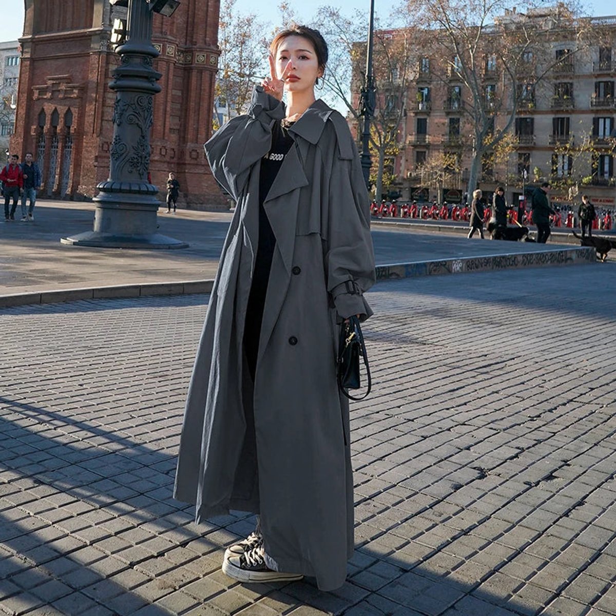 Kay oversized maxi trench coat in grey, worn open over black outfit, front view