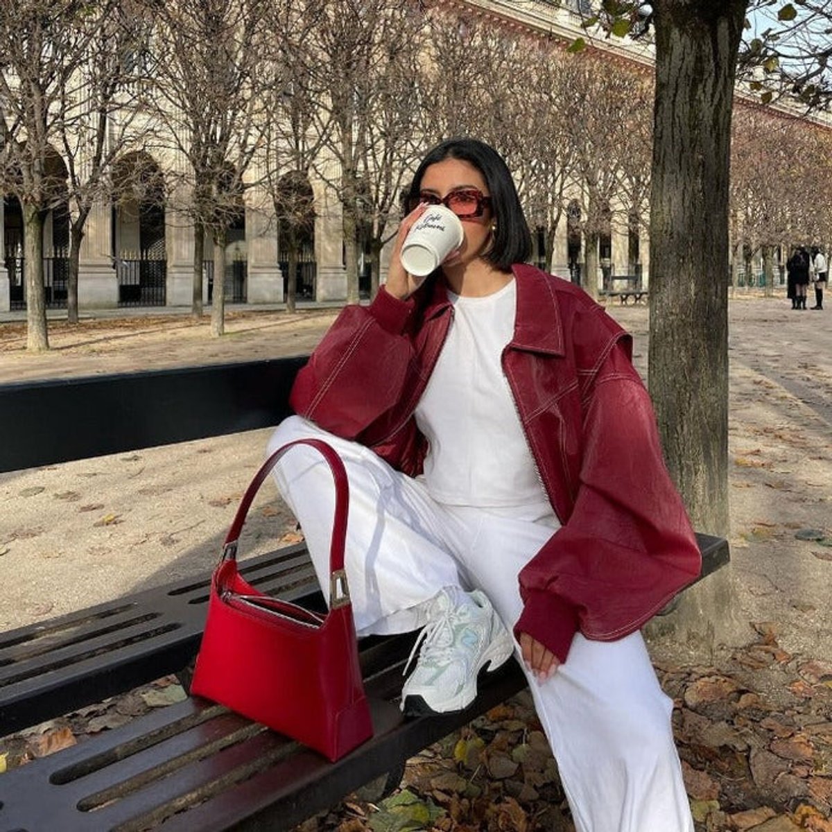 Joyce oversized bomber jacket in wine red, seated autumn street view