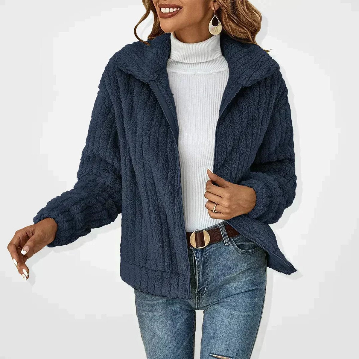 Rita plush zip-up jacket in navy, worn open over a white roll-neck